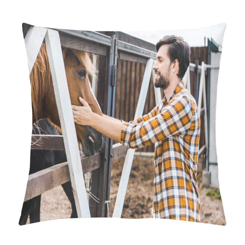 Personality  Side View Of Handsome Smiling Farmer Palming Brown Horse In Stable Pillow Covers