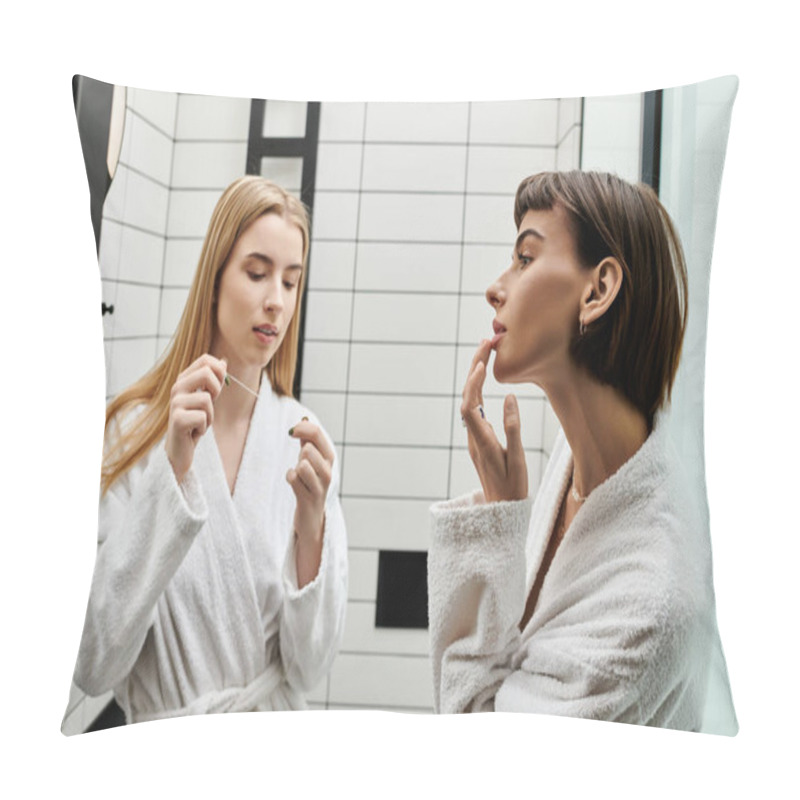 Personality  A Young Woman In A Bathrobe Flossing Her Teeth While Looking At Her Partner In A Hotel Bathroom. Pillow Covers