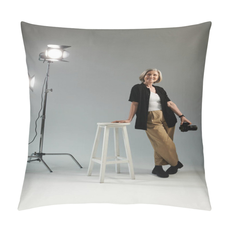 Personality  A Middle-aged Woman Stands Beside A Stool In Front Of A Bright Studio Light, Posing With Camera Pillow Covers