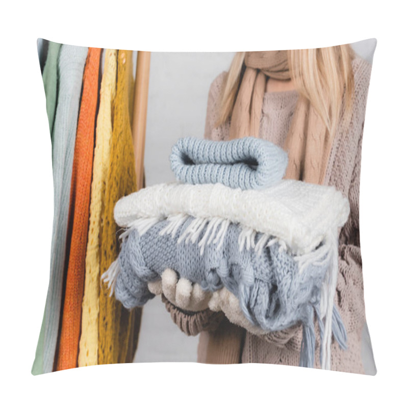 Personality  Cropped View Of Woman Holding Knitwear Near Hanger Rack With Sweaters On White Background Pillow Covers