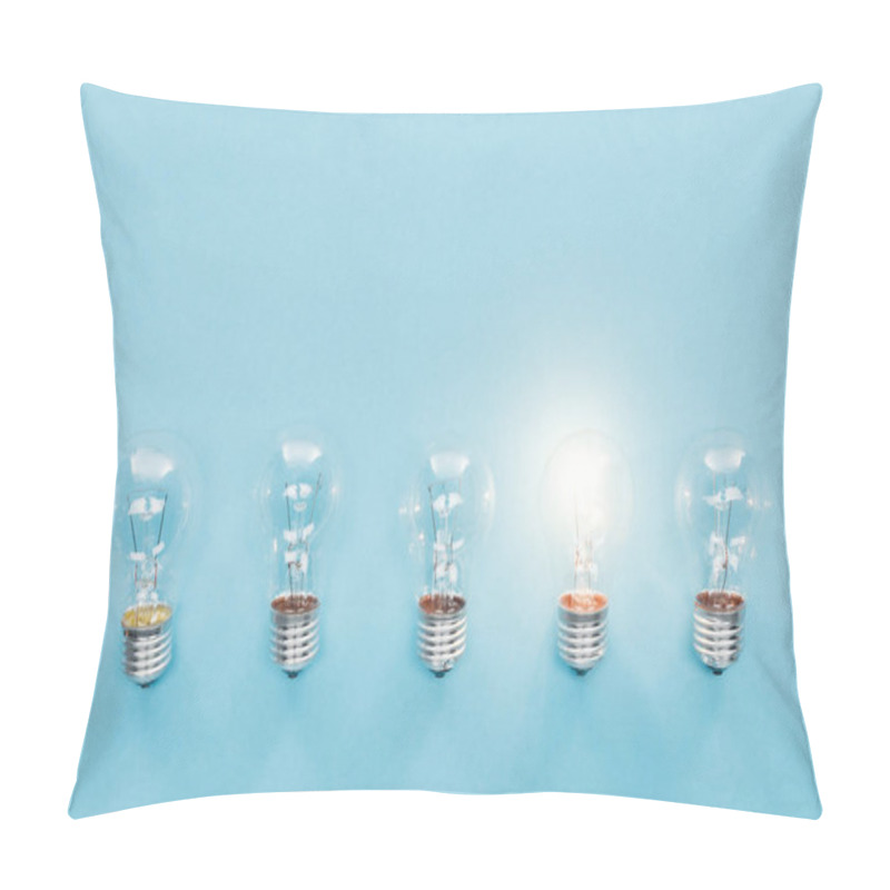 Personality  Top View Of Light Bulbs In Row And One Of Them Glowing On Blue Background, Having New Idea Concept Pillow Covers