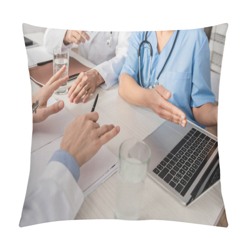 Personality  Cropped View Of African American Nurse Pointing With Hand At Laptop Near Colleagues At Workplace With Papers In Hospital Pillow Covers