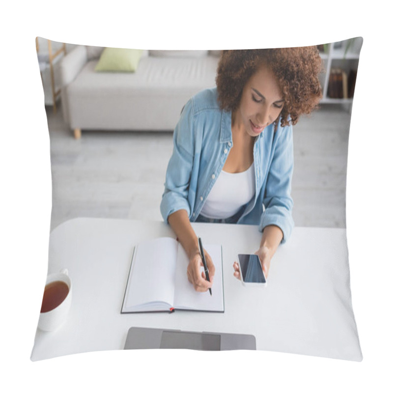 Personality  African American Freelancer Using Mobile Phone And Writing On Notebook Near Tea At Home  Pillow Covers