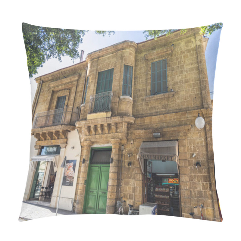 Personality  A Charming Historic Building With Classic Stone Architecture, Green Wooden Shutters, And Commercial Spaces On The Ground Floor, Located On A Shaded Street. Nicosia, Cyprus - October 26, 2024. Pillow Covers