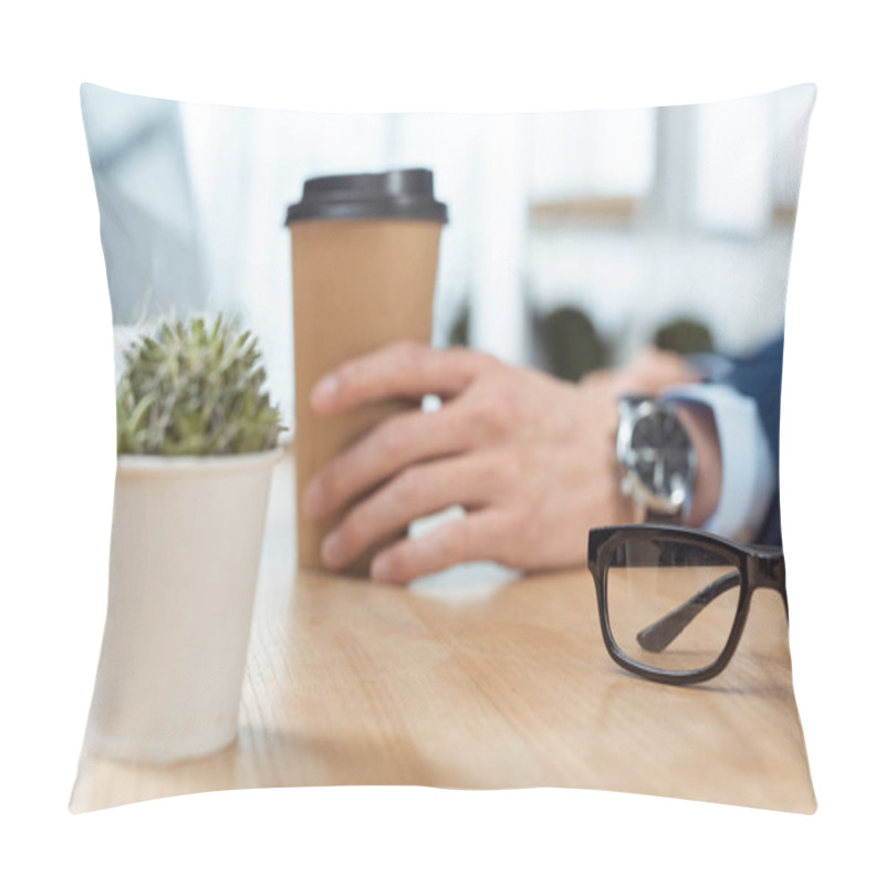 Personality  Cropped Image Of Businessman Sitting With Disposable Coffee Cup At Table With Potted Plant And Eyeglasses In Modern Office  Pillow Covers