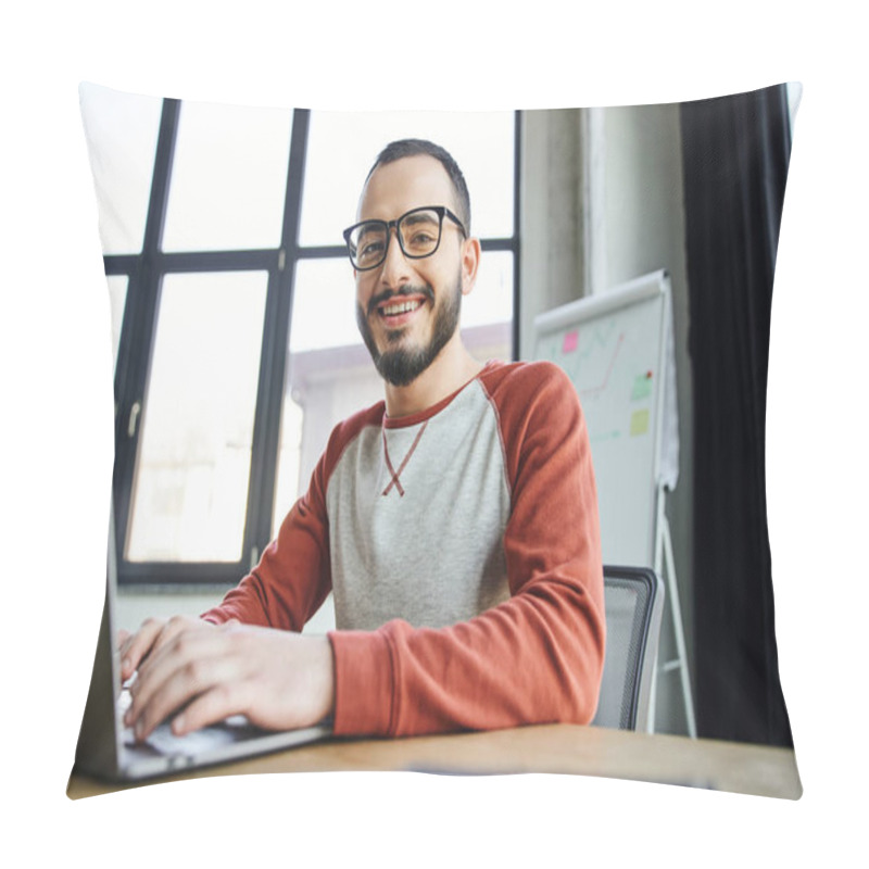 Personality  Youthful And Smiling Bearded Businessman In Eyeglasses Typing On Laptop And Looking At Camera In Front Of Flip Chart With Graphs On Blurred Background In Contemporary Office Pillow Covers