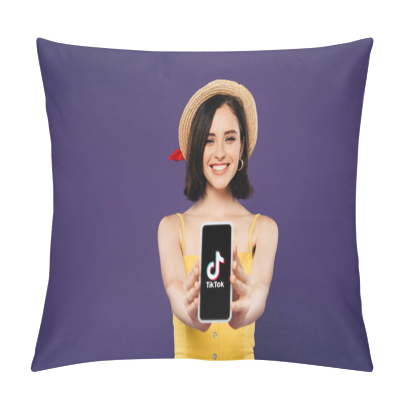 Personality  KYIV, UKRAINE - JULY 3, 2019: Selective Focus Of Smiling Pretty Girl In Straw Hat Presenting Smartphone With Tiktok App Isolated On Purple  Pillow Covers