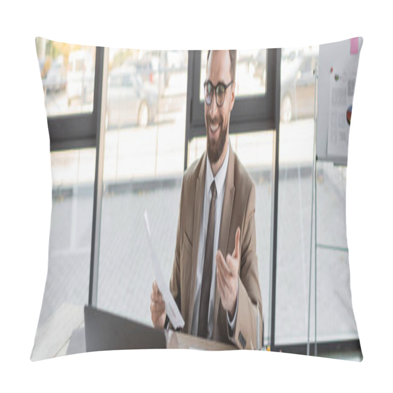 Personality  Happy And Successful Entrepreneur In Stylish Eyeglasses, Beige Blazer And Tie Holding Document And Pointing With Hand During Video Conference On Laptop Near Notebooks In Modern Office, Banner Pillow Covers