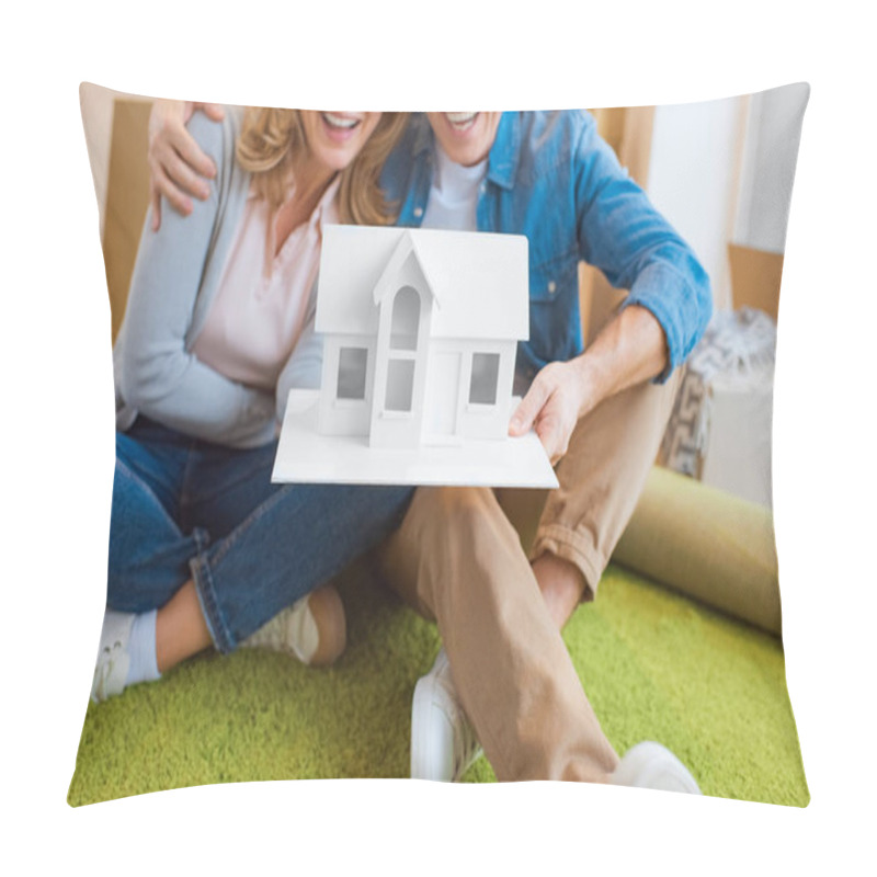 Personality  Selective Focus Happy Couple Holding House Model While Sitting On Green Carpet Pillow Covers