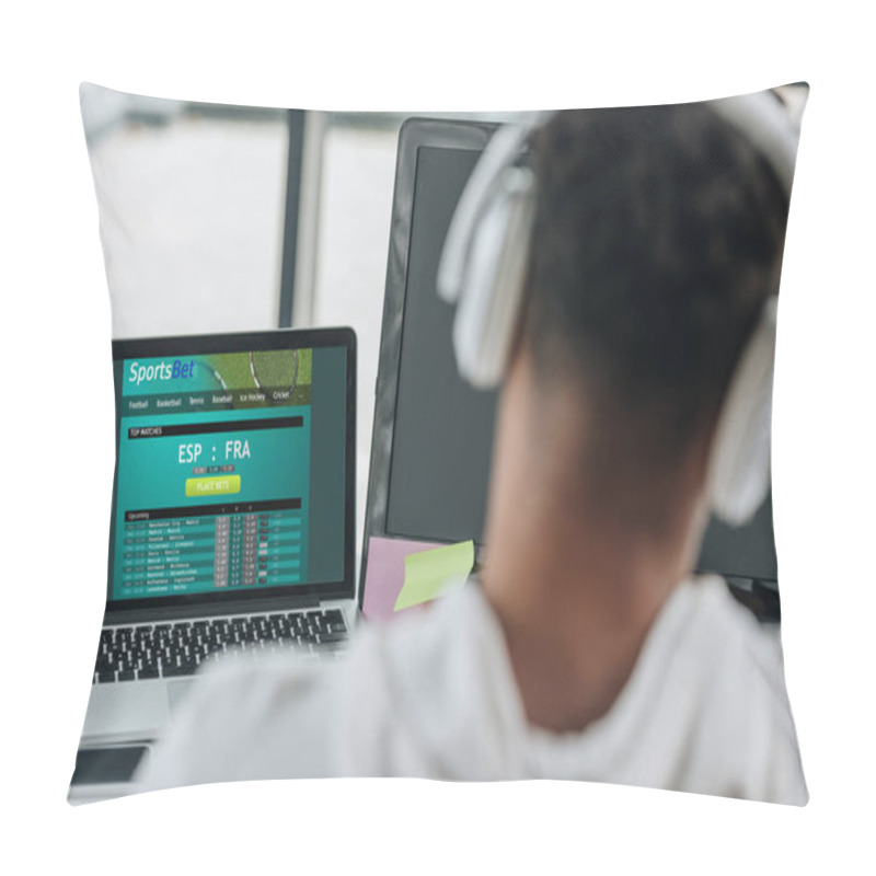 Personality  KYIV, UKRAINE - JULY 29, 2019: Back View Of African American Programmer In Headphones Sitting Near Laptop With Sportsbet Website On Screen Pillow Covers