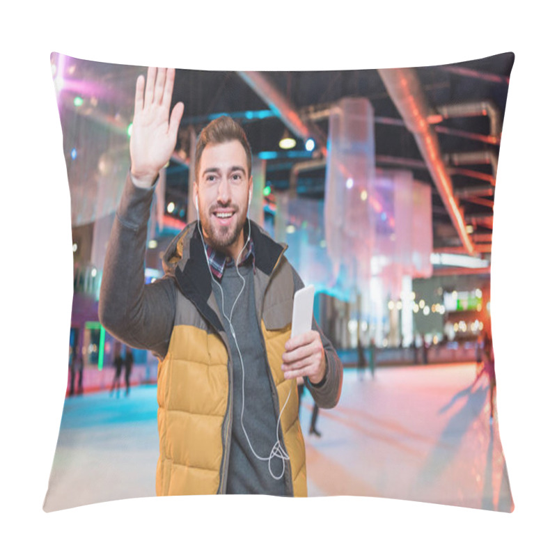 Personality  Smiling Young Man In Earphones Holding Smartphone And Waving Hand While Standing On Rink Pillow Covers