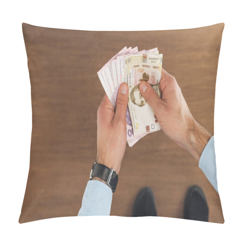 Personality  Top View Of Man Holding Hryvnias Banknotes On Wooden Background Pillow Covers