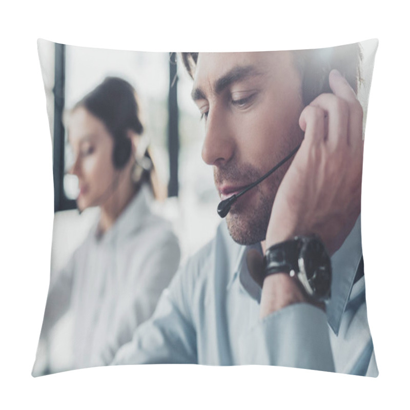 Personality  Handsome Call Center Manager In Headphones With Mike Sitting At Workplace While His Colleague Sitting On Background Pillow Covers