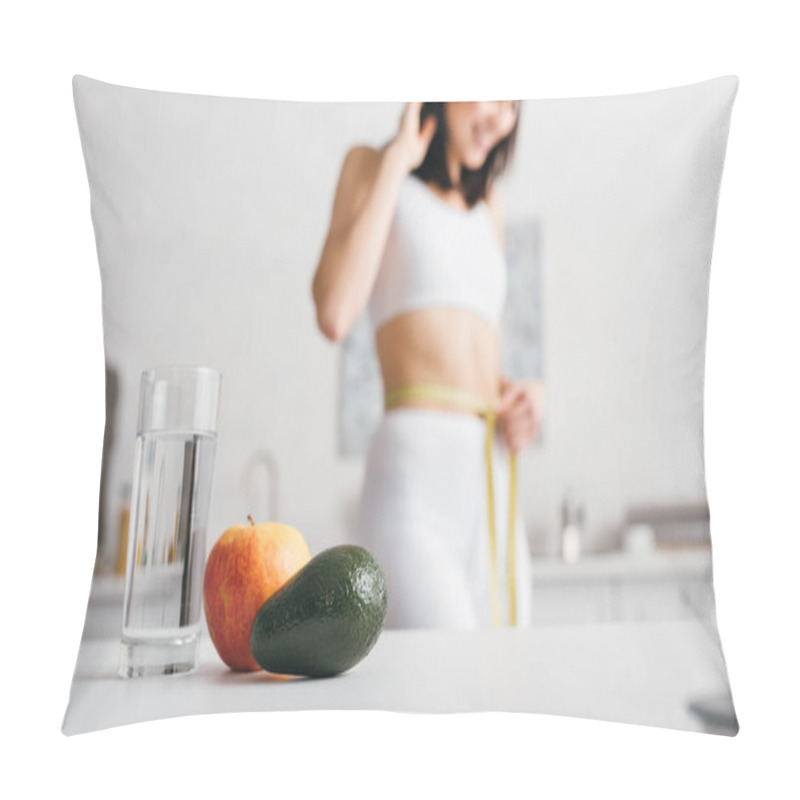 Personality  Selective Focus Of Glass Of Water And Fruits On Table And Smiling Sportswoman Measuring Waist With Tape In Kitchen  Pillow Covers