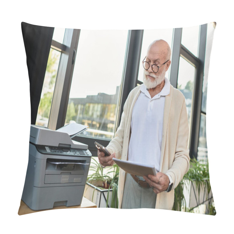 Personality  A Good-looking Senior Businessman Checks His Phone While Managing Paperwork In A Sleek, Sunlit Office Setting. Pillow Covers