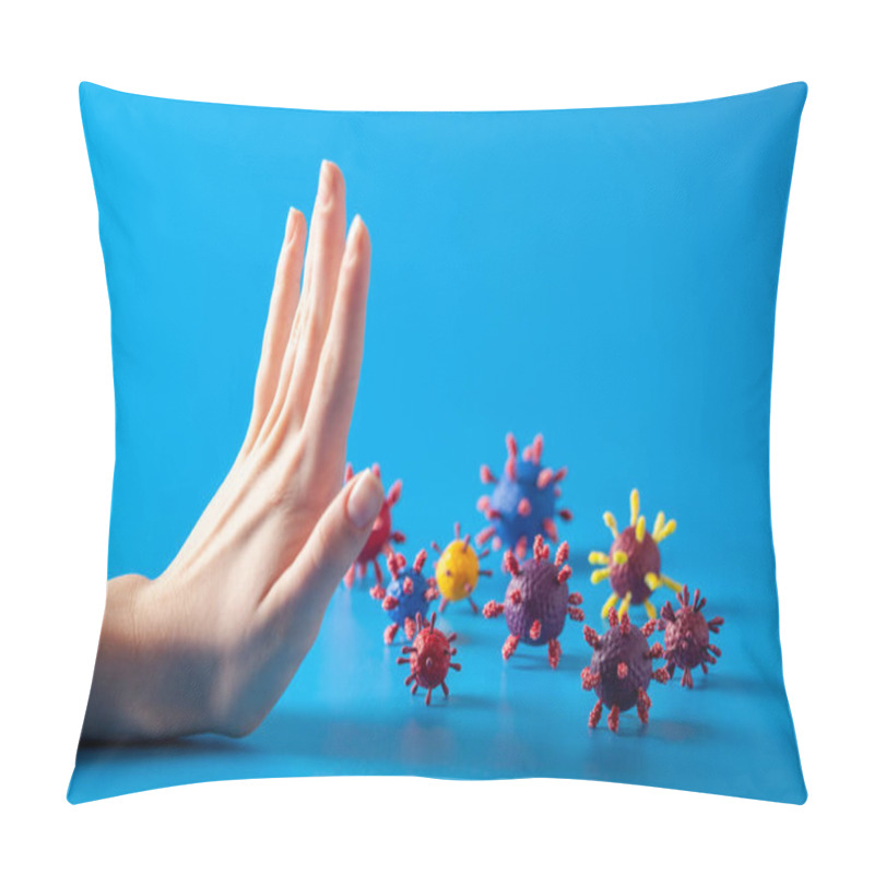 Personality  Stop Epidemic Concept. COVID-19 Pandemic Coronavirus. Woman Hand And Artificial Models Of Viruses On A Blue Background. Pillow Covers