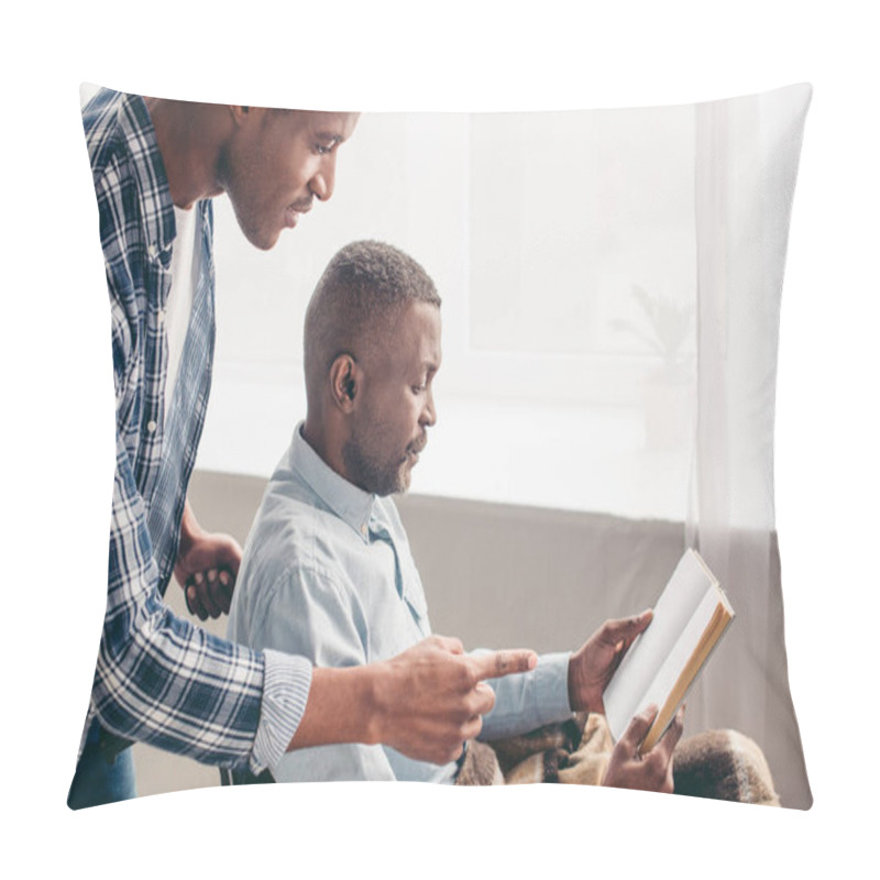 Personality  Adult Son Looking At Senior Father Reading Book In Wheelchair  Pillow Covers