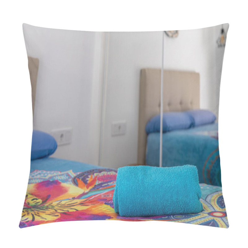 Personality  Brightly Decorated Bedroom Featuring A Blue Rolled Towel On A Vibrant Floral Bedspread, Mirrored Wardrobe, And Beige Headboard. Pillow Covers