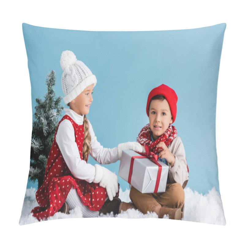 Personality  Kids In Hats And Winter Outfit Sitting On Snow And Touching Present Isolated On Blue Pillow Covers