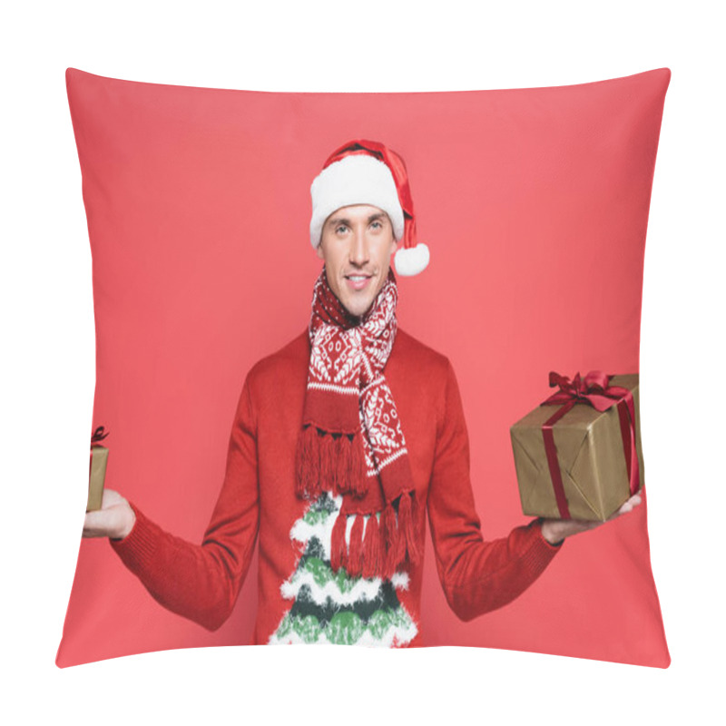 Personality  Smiling Man In Santa Hat Holding Gift Boxes And Looking At Camera On Red Background Pillow Covers