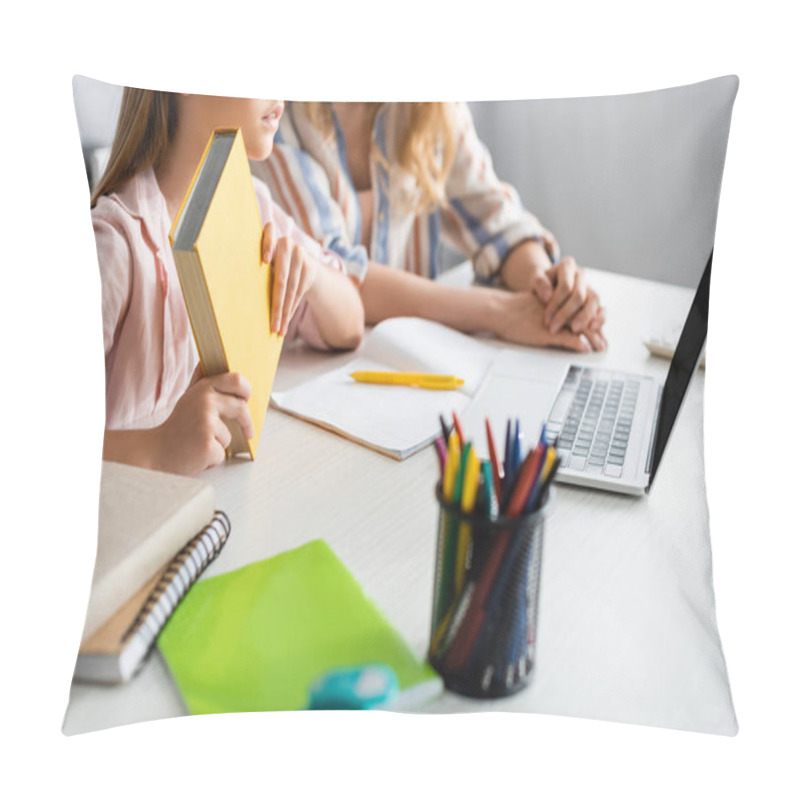 Personality  Cropped View Of Kid Holding Book During Electronic Learning Near Mother At Home  Pillow Covers