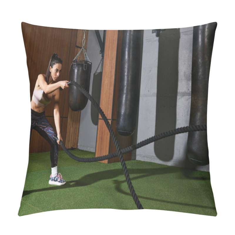 Personality  A Dedicated Woman Engages In An Intense Exercise Routine Using Battle Ropes In A Gym. Pillow Covers