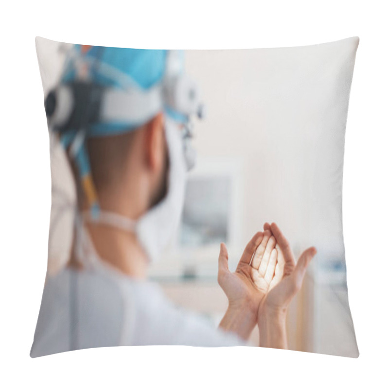 Personality  Doctor Surgeon In Medical Mask In Professional Magnifying Glasses Shines On His Hand With A Flashlight, Preparing For Surgery. Back View Pillow Covers