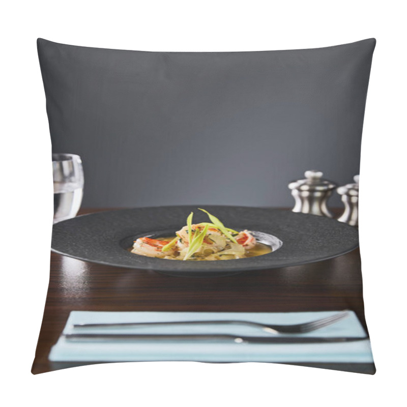 Personality  Selective Focus Of Delicious Restaurant Soup With Shrimps In Black Plate Served On Napkin With Cutlery And Water On Black Background Pillow Covers