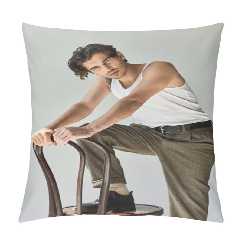 Personality  A Stylish Young Man Showcasing A Tattoo Leans On A Chair In A Tank Top, Exuding Charm And Confidence. Pillow Covers