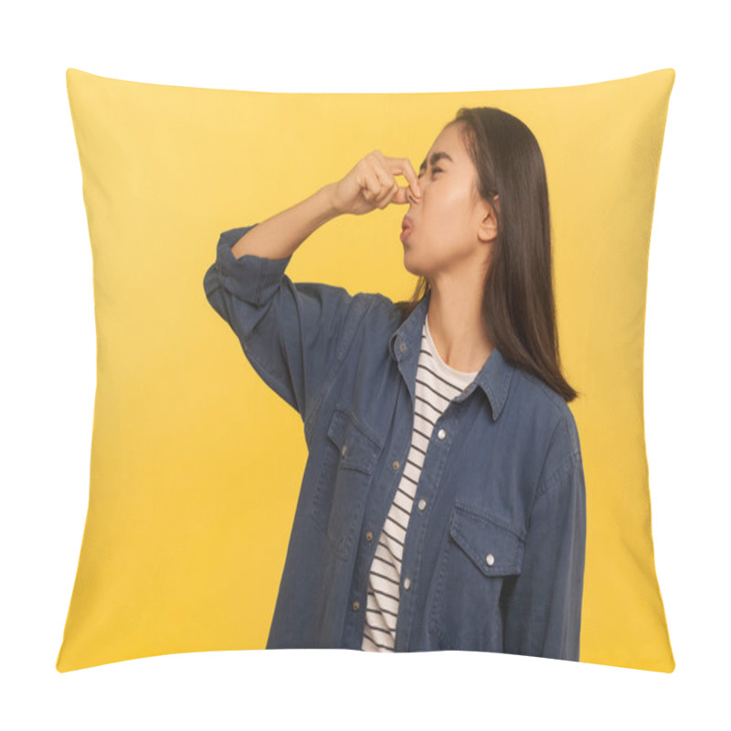 Personality  Awful Smell! Portrait Of Girl In Denim Shirt Grimacing In Disgust And Holding Breath, Grabbing Nose With Fingers, Avoiding Stinky Odor, Fart Gases. Indoor Studio Shot Isolated On Yellow Background Pillow Covers