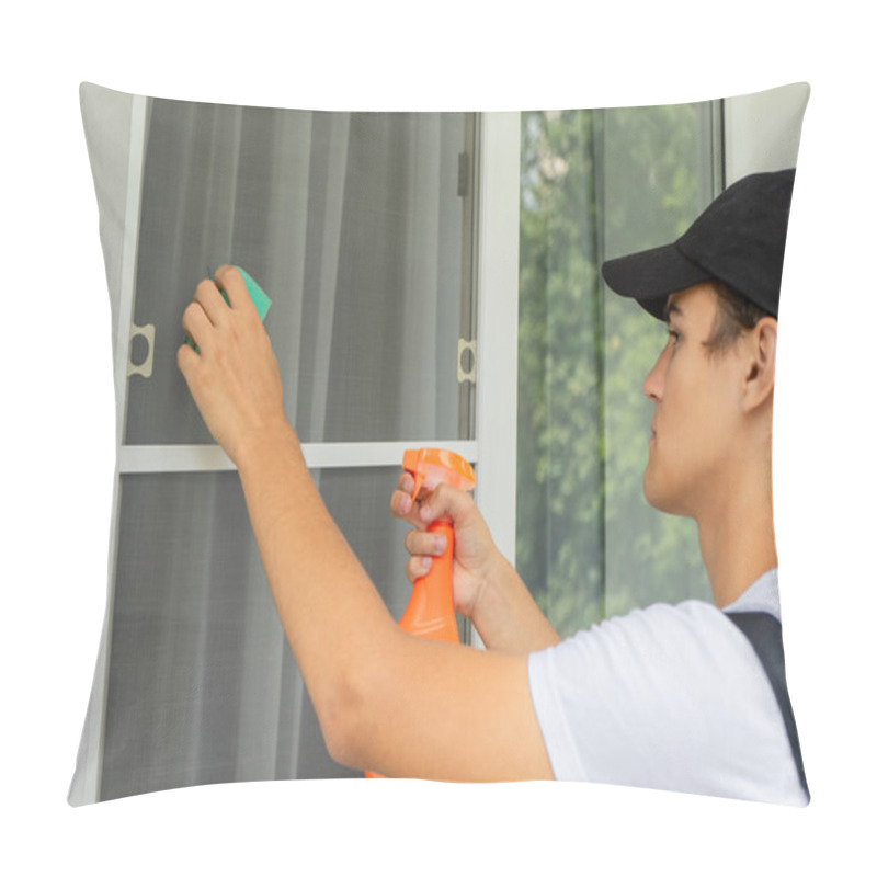 Personality  A Cleaning Service Employee Washes The Window And Mosquito Net With A Sponge And Spray Pillow Covers