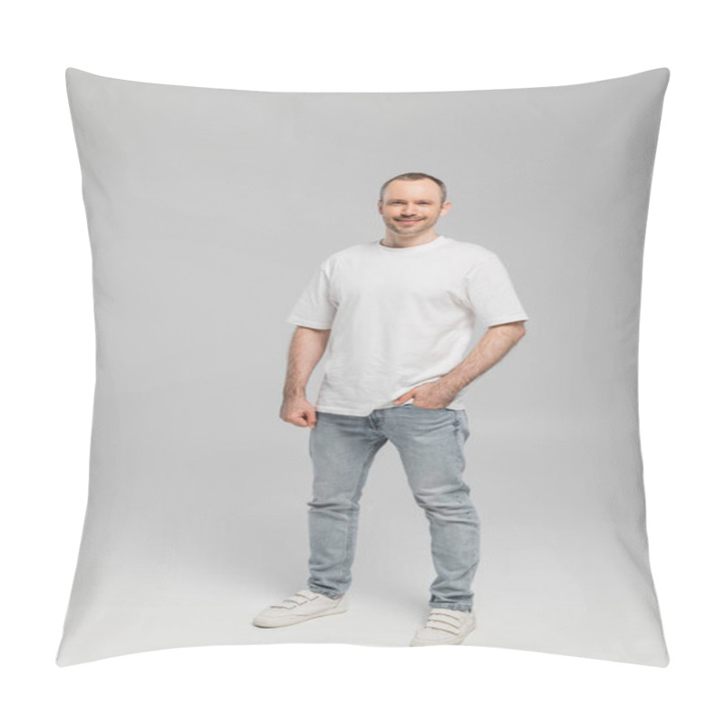 Personality  Full Length Of Unshaved Happy Man With Bristle Standing In White T-shirt And Posing With Hand In Pocket Of Blue Denim Jeans While Looking At Camera On Grey Background In Studio, Happiness  Pillow Covers