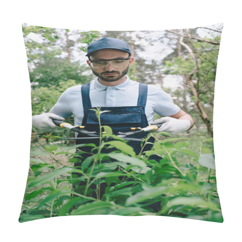 Personality  Attentive Gardener In Protective Glasses And Cap Cutting Bushes With Trimmer In Park Pillow Covers