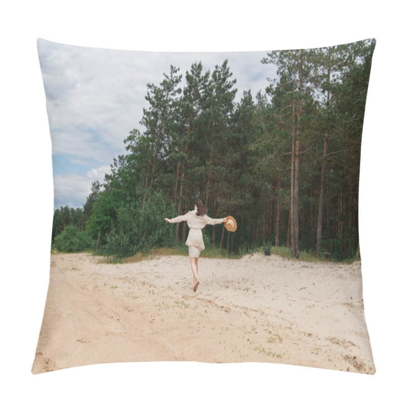 Personality  Back View Of Young Woman With Outstretched Hands Holding Straw Hat And Walking Near Forest Pillow Covers