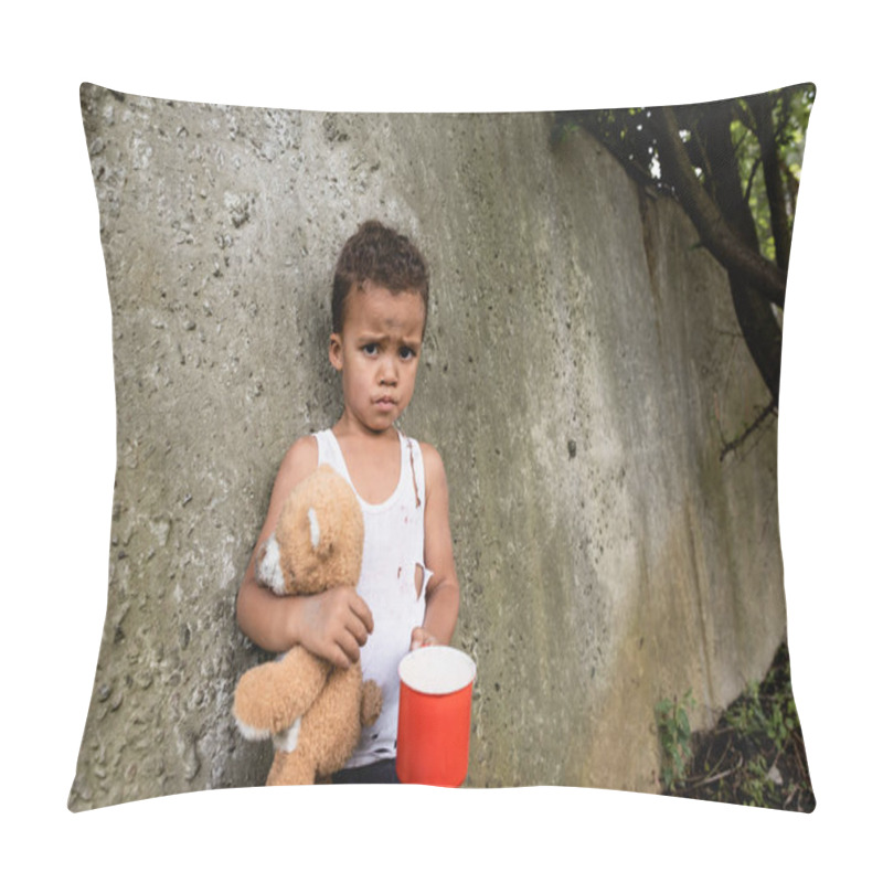 Personality  Displeased African American Boy Holding Dirty Teddy Bear And Metal Cup Near Concrete Wall On Urban Street  Pillow Covers