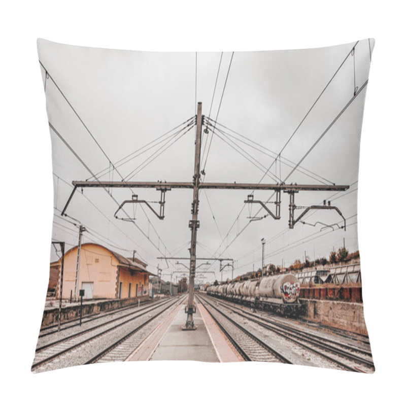 Personality   Empty Railway Station With Power Lines. Symmetrical View Of An Empty Railway Station Platform With Overhead Power Lines On A Cloudy Day. The Scene Evokes Solitude And Industrial Simplicity. Pillow Covers