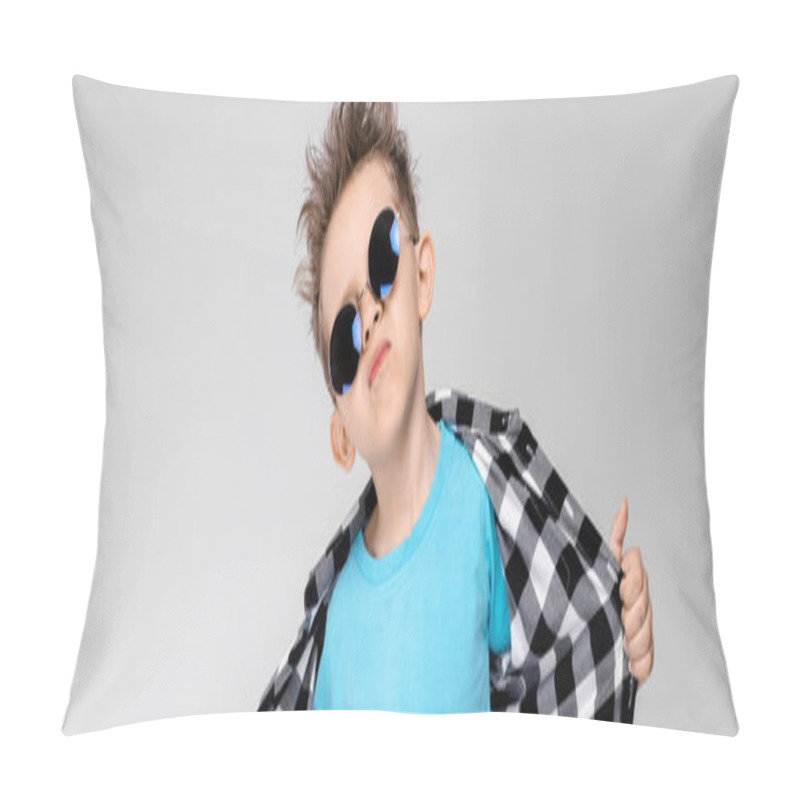 Personality  A Handsome Boy In A Plaid Shirt, Blue Shirt And Jeans Stands On A Gray Background. The Boy Is Wearing Round Glasses. The Boy Smiles And Pulls His Shirt Away Pillow Covers