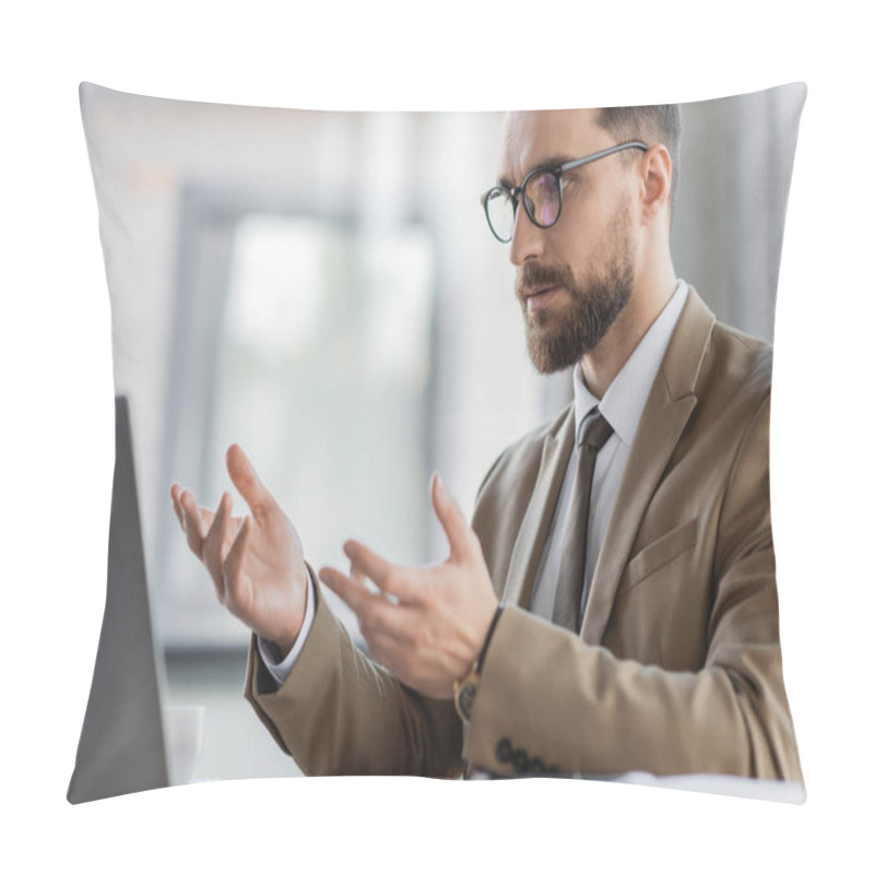 Personality  Ambitious And Bearded Businessman In Beige Stylish Blazer, Tie And Eyeglasses Gesturing During Video Conference On Laptop While Sitting At Work Desk In Office Pillow Covers