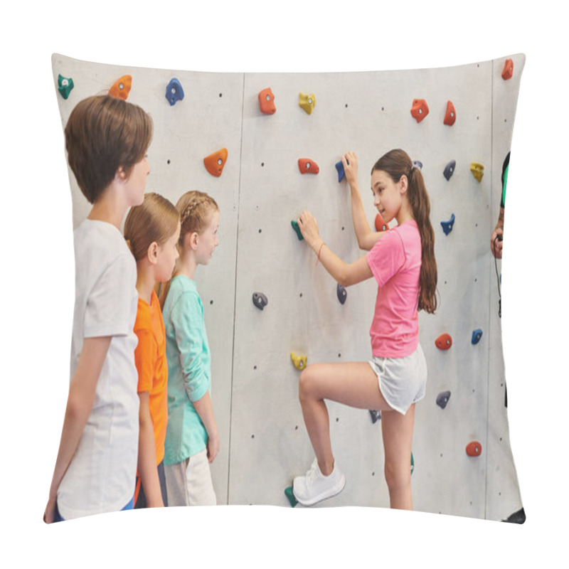 Personality  A Man Teaches A Diverse Group Of Children How To Climb A Rock Wall In A Vibrant, Energetic Environment. Pillow Covers