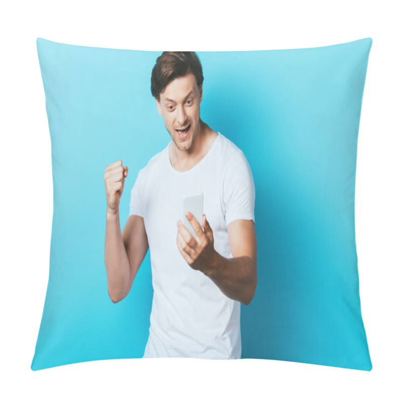 Personality  Man Looking At Smartphone And Showing Yeah Gesture On Blue Background Pillow Covers