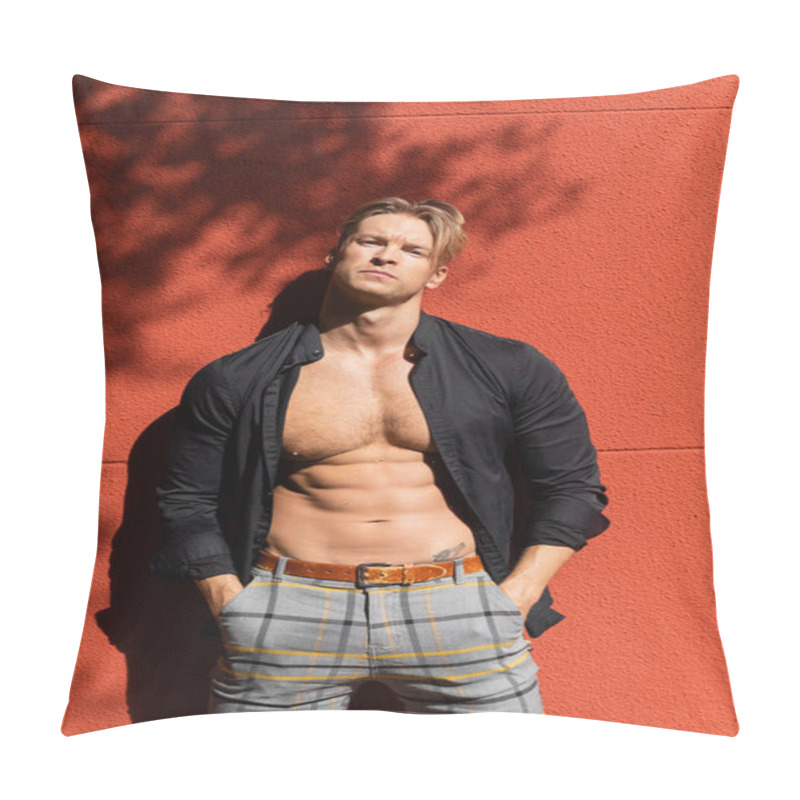 Personality  A Muscular Man With Blonde Hair Poses Against A Red Wall, Wearing A Black Shirt Unbuttoned To Reveal His Toned Physique. Pillow Covers