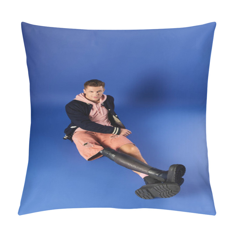 Personality  Young Man Confidently Displays His Prosthetic Leg While Seated On A Blue Backdrop. Pillow Covers