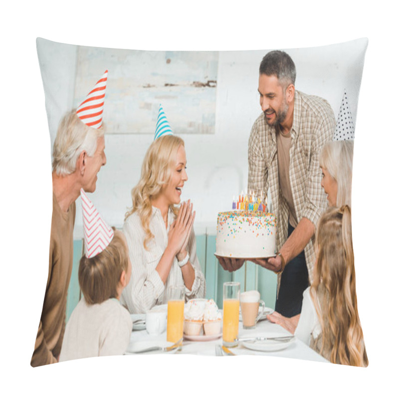 Personality  Smiling Man Holding Birthday Cake With Candles Near Happy Family Sitting At Kitchen Table Pillow Covers