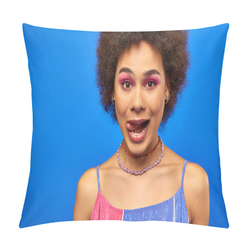 Personality  Portrait Of Stylish Young African American Woman With Natural Hair And Bold Makeup Sticking Out Tongue And Looking At Camera While Standing Isolated On Blue, Charismatic Model In Summer Outfit Pillow Covers