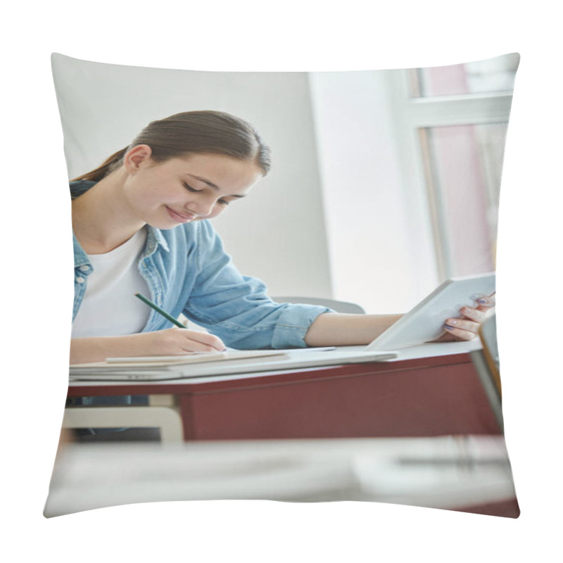 Personality  Smiling Teenage Pupil Using Digital Tablet And Writing On Notebook During Lesson In Classroom Pillow Covers