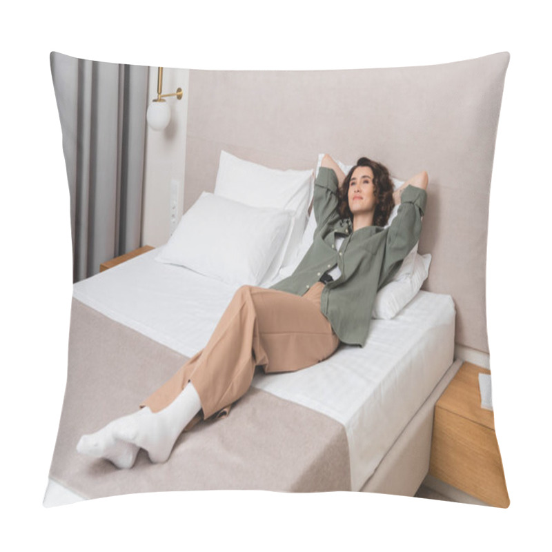 Personality  Full Length Of Young Delighted Woman With Wavy Brunette Hair Lying On Bed And White Pillows In Casual Clothes Near Bedside Table, Books And Wall Sconce In Contemporary Hotel Room Pillow Covers