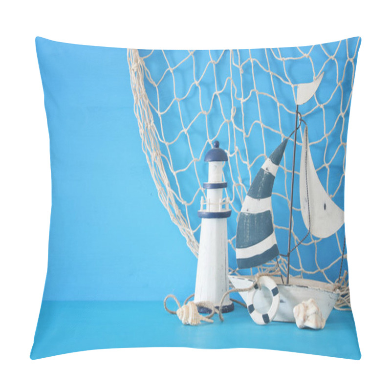 Personality  Nautical Concept With White Decorative Sail Boat, Lighthouse, Seashells And Fishnet Over Blue Wooden Table And Background. Pillow Covers