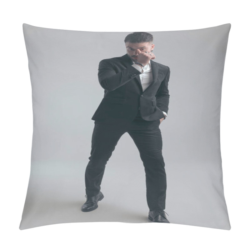 Personality  Handsome Elegant Man Holding Hand In Pocket And Scratching Nose, Wearing Suit While Walking On Gray Studio Background Pillow Covers