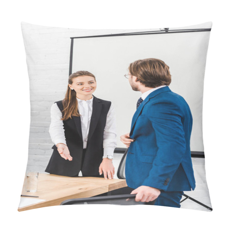 Personality  Smiling Young Businesswoman Pointing Where To Seat To Her Colleague At Conference Room Pillow Covers