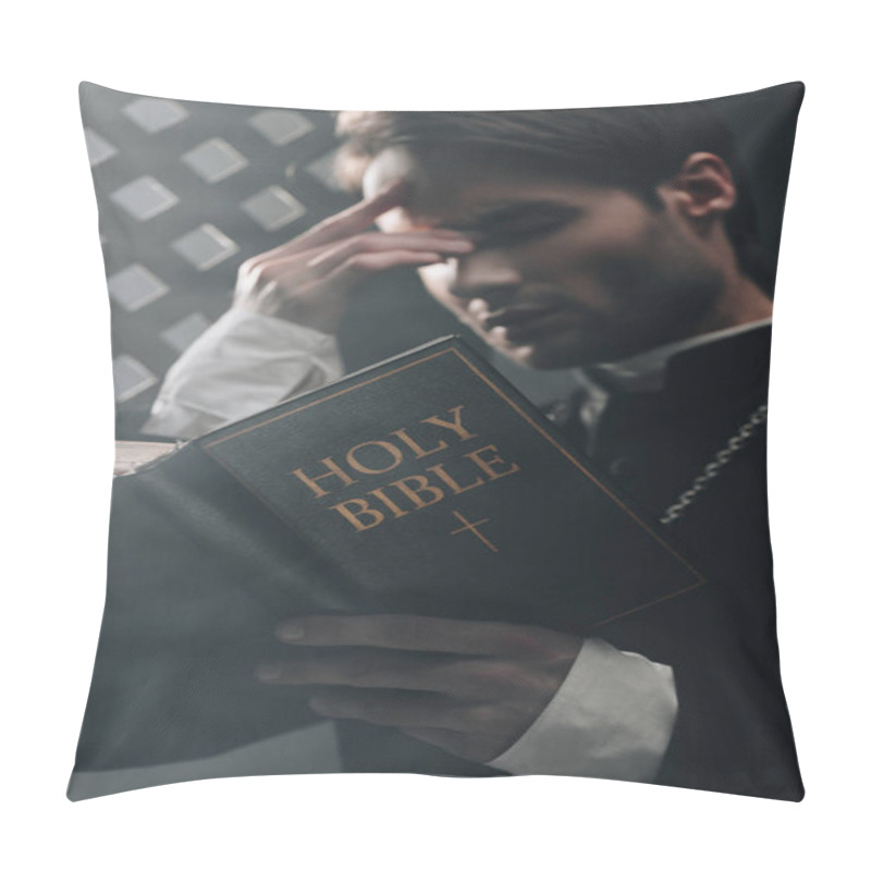 Personality  Young Serious Catholic Priest Touching Face While Reading Bible Near Confessional Grille In Dark With Rays Of Light Pillow Covers